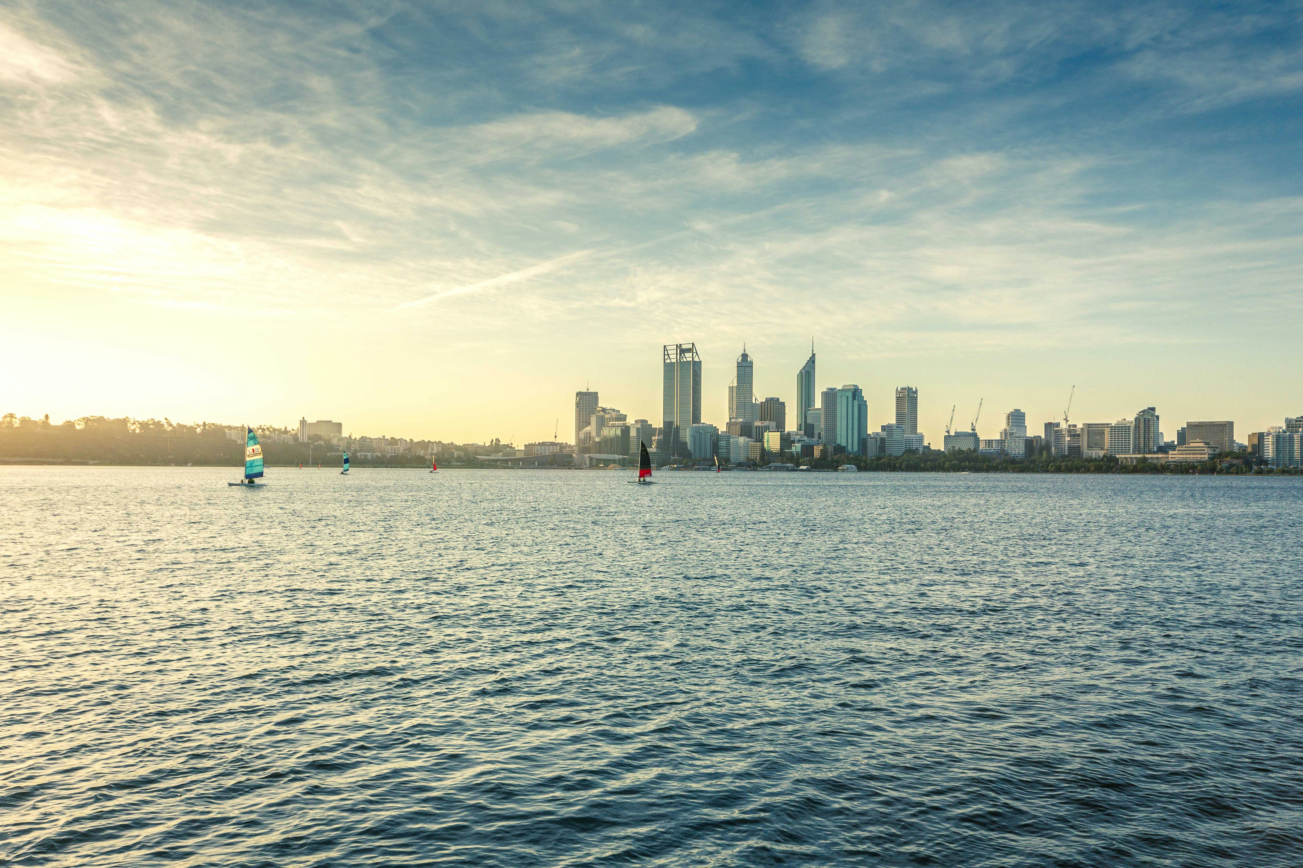 city skyline across body of water during daytime